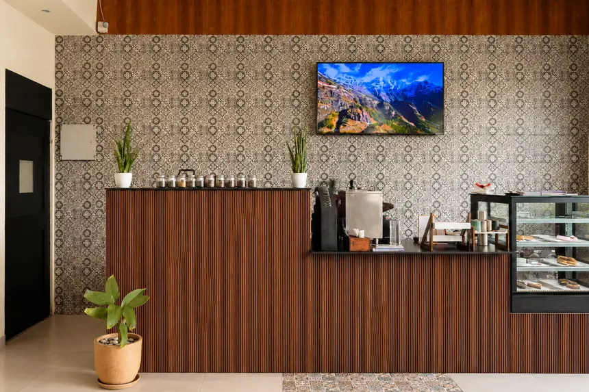 A corner booth framed by plants