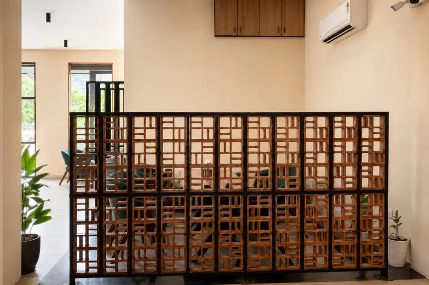 A carved wooden jali screen dividing the room